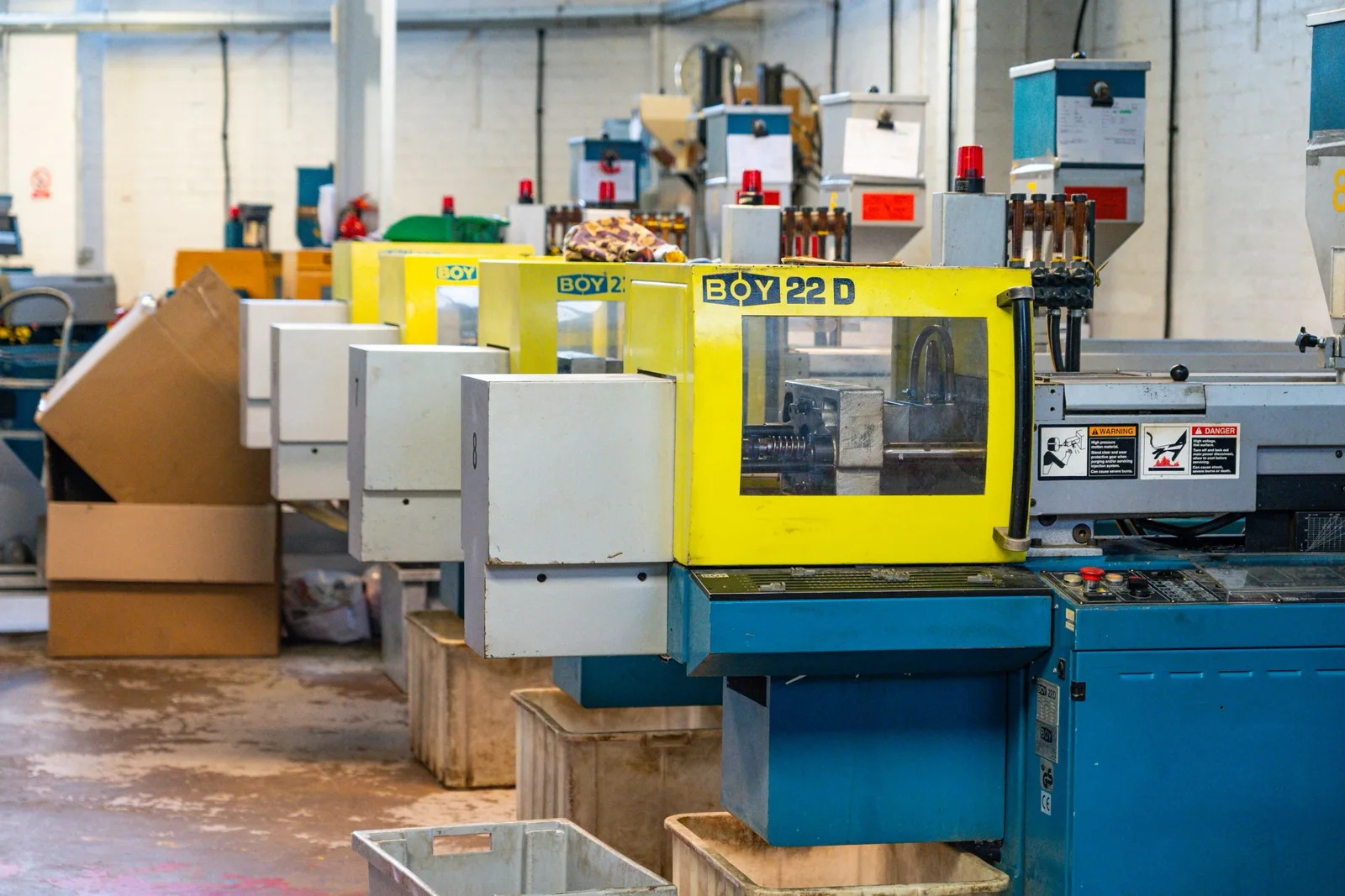 Injection moulding machinery inside the Malvern Plastics manufacturing workshop
